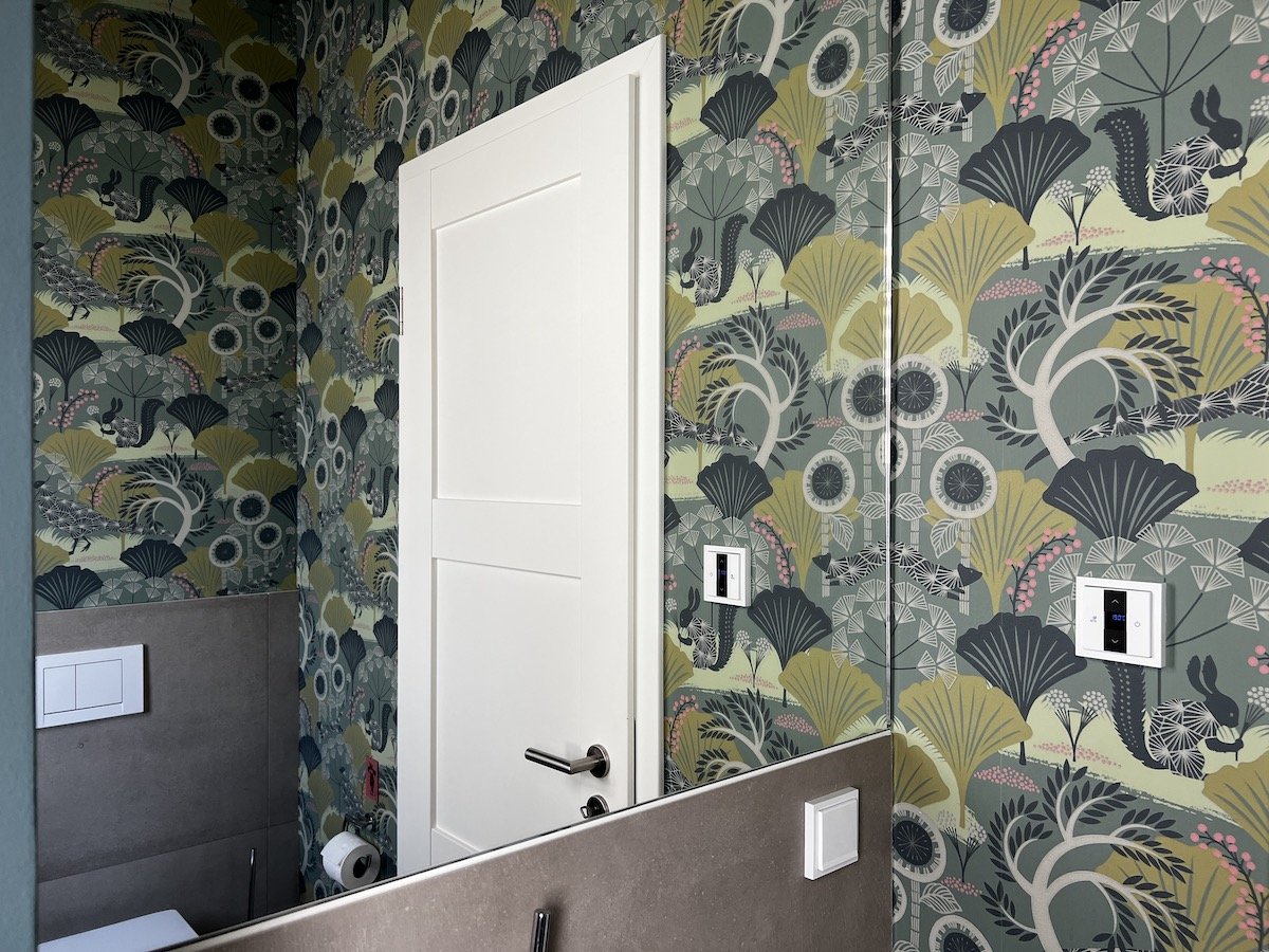 Bathroom with green wallpaper