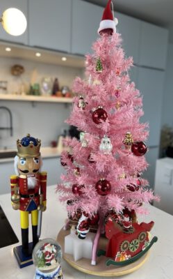 Small pink christmas tree with red decoration